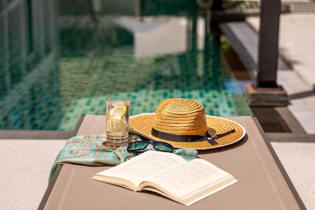 Outrigger Surin Beach Resort - Sha Extra Plus Kültér fotó A poolside table